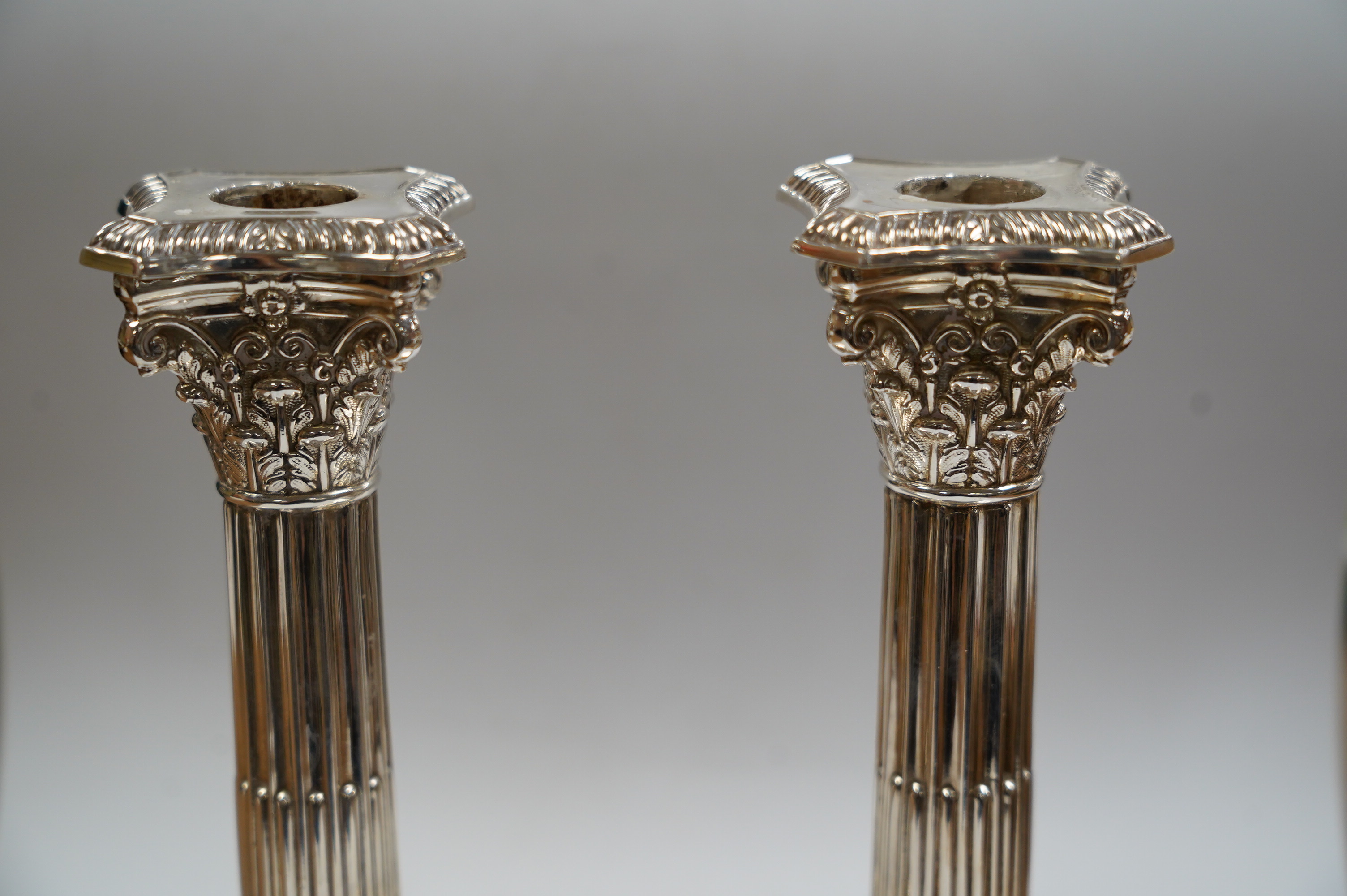 A pair of modern silver Corinthian column dwarf candlesticks, by James Dixon & Sons Ltd, Sheffield, 1991, height 16.4cm, weighted. Condition - fair